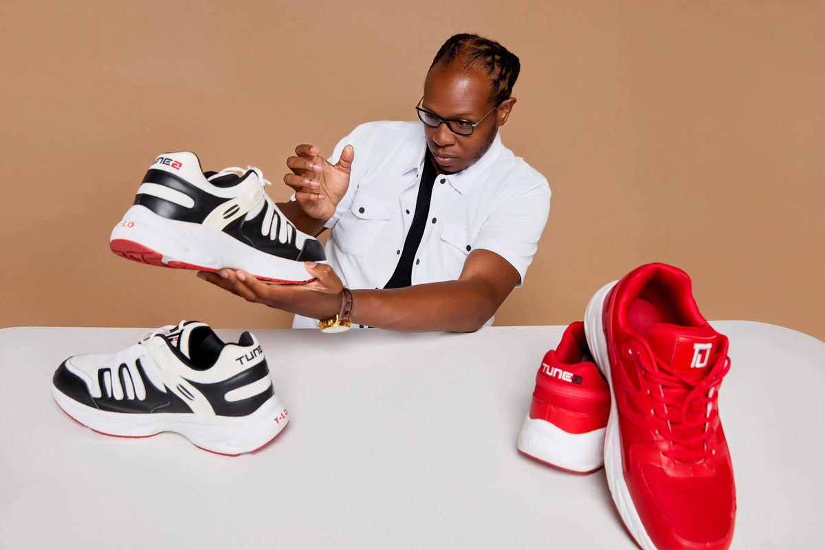 Tunez Footwear founder holding sneakers while discussing standing comfort